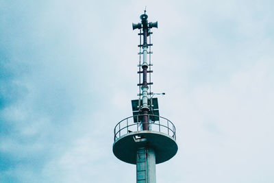 Low angle view of communications tower against sky