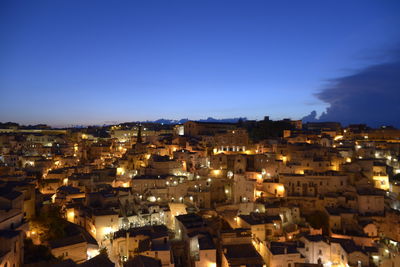 High angle view of illuminated townscape against sky at night