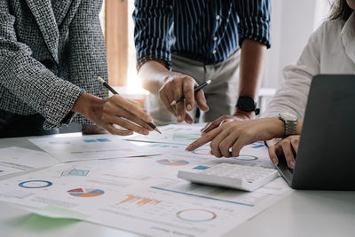 Midsection of business colleagues working at office