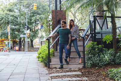 Full length of couple standing on steps