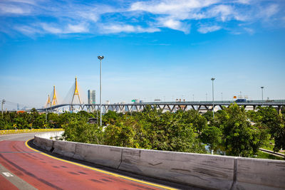 Bridge over street against blue sky