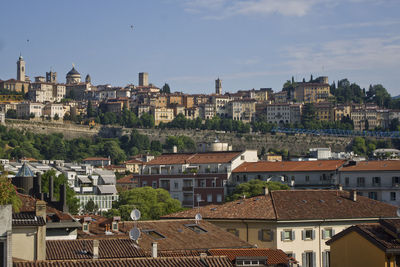 High angle view of houses in town against sky