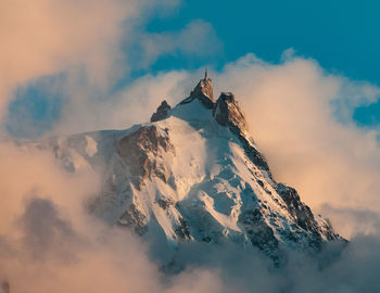 Scenic view of snow covered mountains against sky