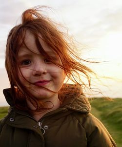 Portrait of cute girl against sky