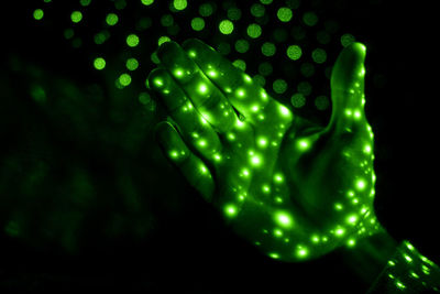 Close-up of hand with laser lights