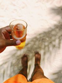 Low section of person holding drink