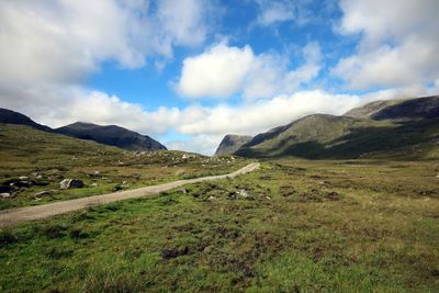 Scenic view of landscape and mountains against sky