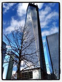 Low angle view of modern building against cloudy sky