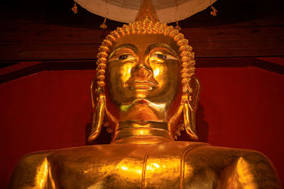 Low angle view of statue against temple building