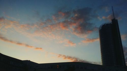 Low angle view of modern building against sky at dusk