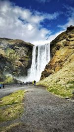 Scenic view of waterfall against sky