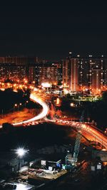 High angle view of illuminated city buildings at night