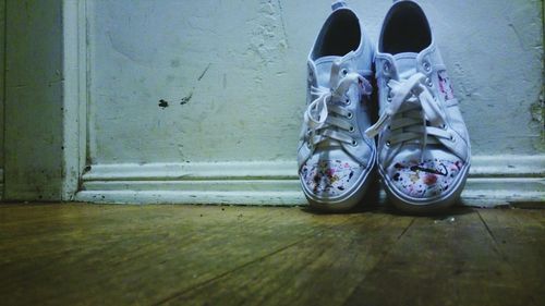 Shoes against wall on floor at home