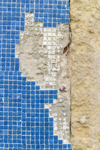 Close-up of weathered tiled wall