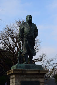 Low angle view of statue against sky