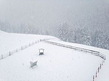 High angle view of fence on snow covered field