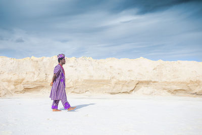 Man standing on beach against sky