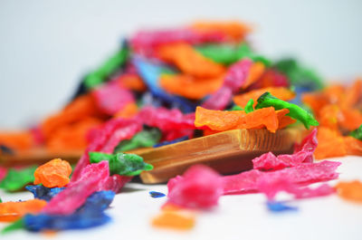 Close-up of chopped fruits on table against white background