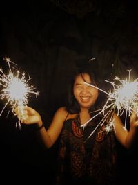 Young woman playing fireworks on new year party