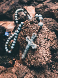 High angle view of rusty chain on rock