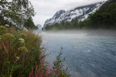 Scenic view of waterfall against sky