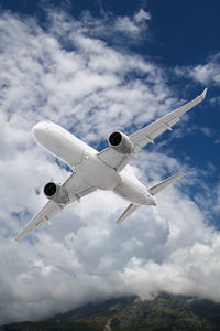Low angle view of airplane flying in sky