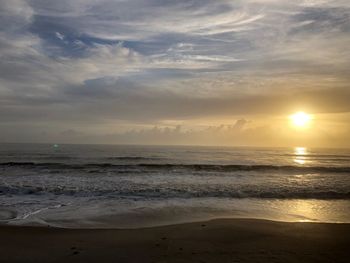 Scenic view of beach against sky during sunset