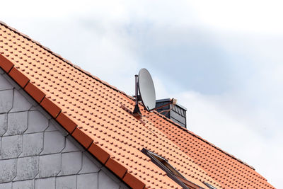 Satellite dish on a red tile roof