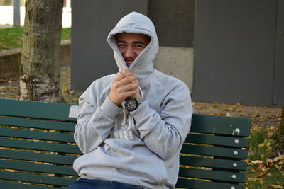 Portrait of boy sitting on bench