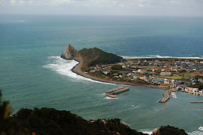 High angle view of sea and cityscape against sky