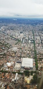 High angle view of city buildings against sky