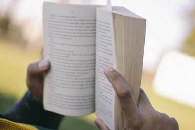 Close-up of hand holding book