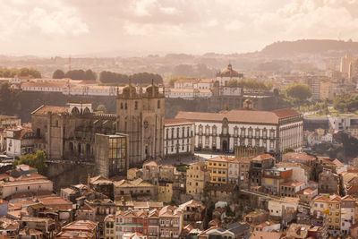 View of cityscape against cloudy sky