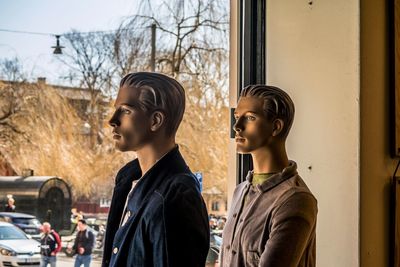 Friends looking away against window