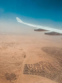 Aerial view of landscape against blue sky
