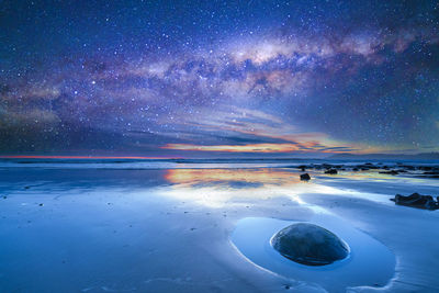 Scenic view of sea against sky at night