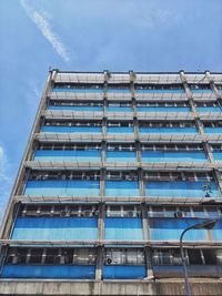 Low angle view of glass building against sky