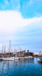 Sailboats moored in swimming pool against sky