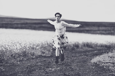 Full length of woman standing on field
