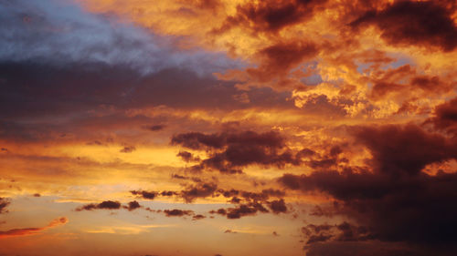 Low angle view of dramatic sky during sunset