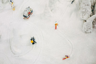High angle view of people skiing in snowy area