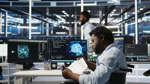 Rear view of man using laptop at airport