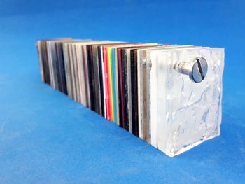 Close-up of open book on table against blue background