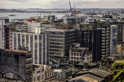 Buildings against cloudy sky