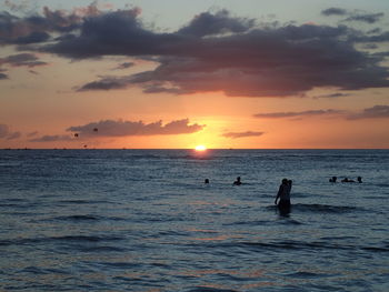 Tourists on beach at sunset