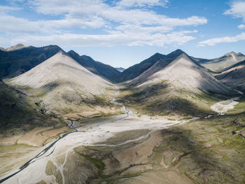 Scenic view of mountains against cloudy sky