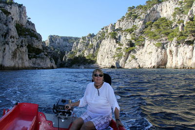 Woman sitting in boat on sea