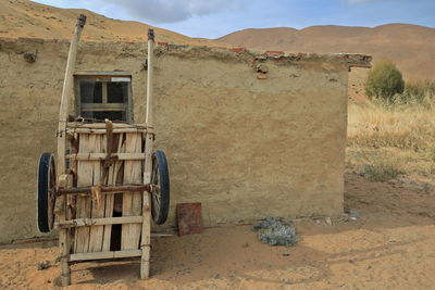 1072 old bike wheeled cart-outer cob wall of a herder's mud hut. lake tamaying-badain jaran-china.