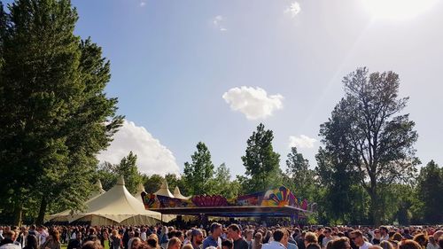 Group of people in park against sky