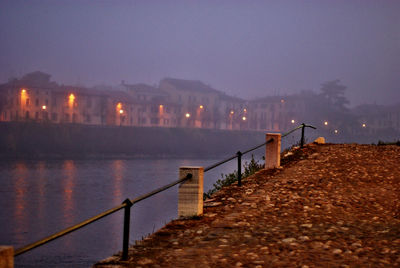 View of illuminated pier at night